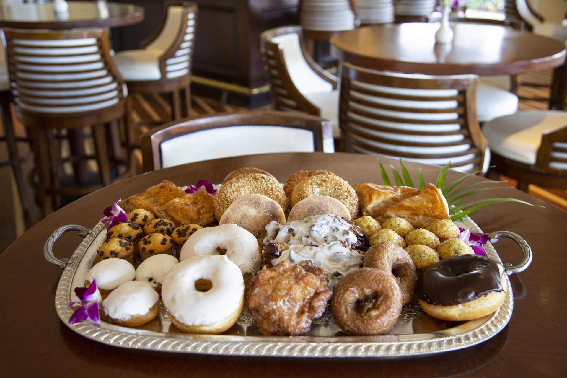 A tray of donuts and pastries on a table