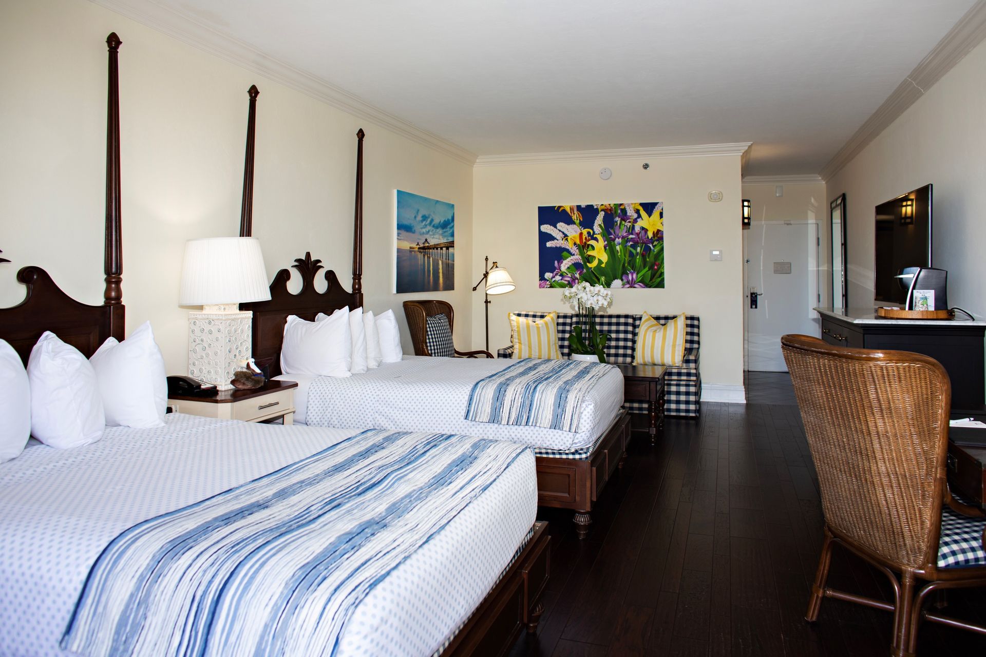 A hotel room with two beds and a desk