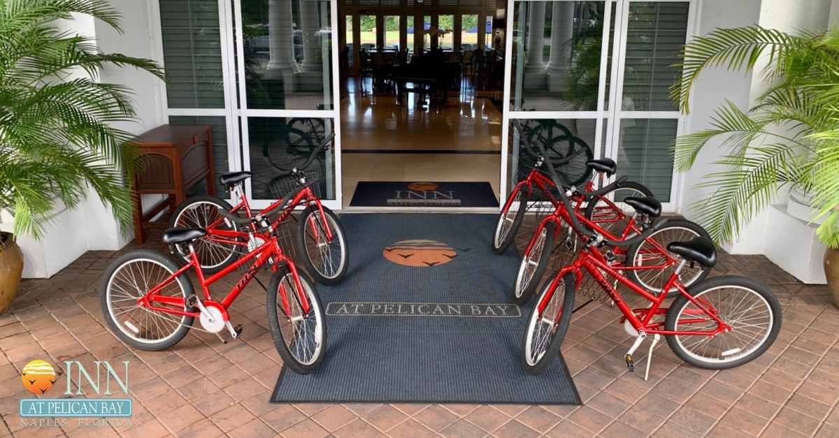 A bunch of red bikes are parked in front of a building