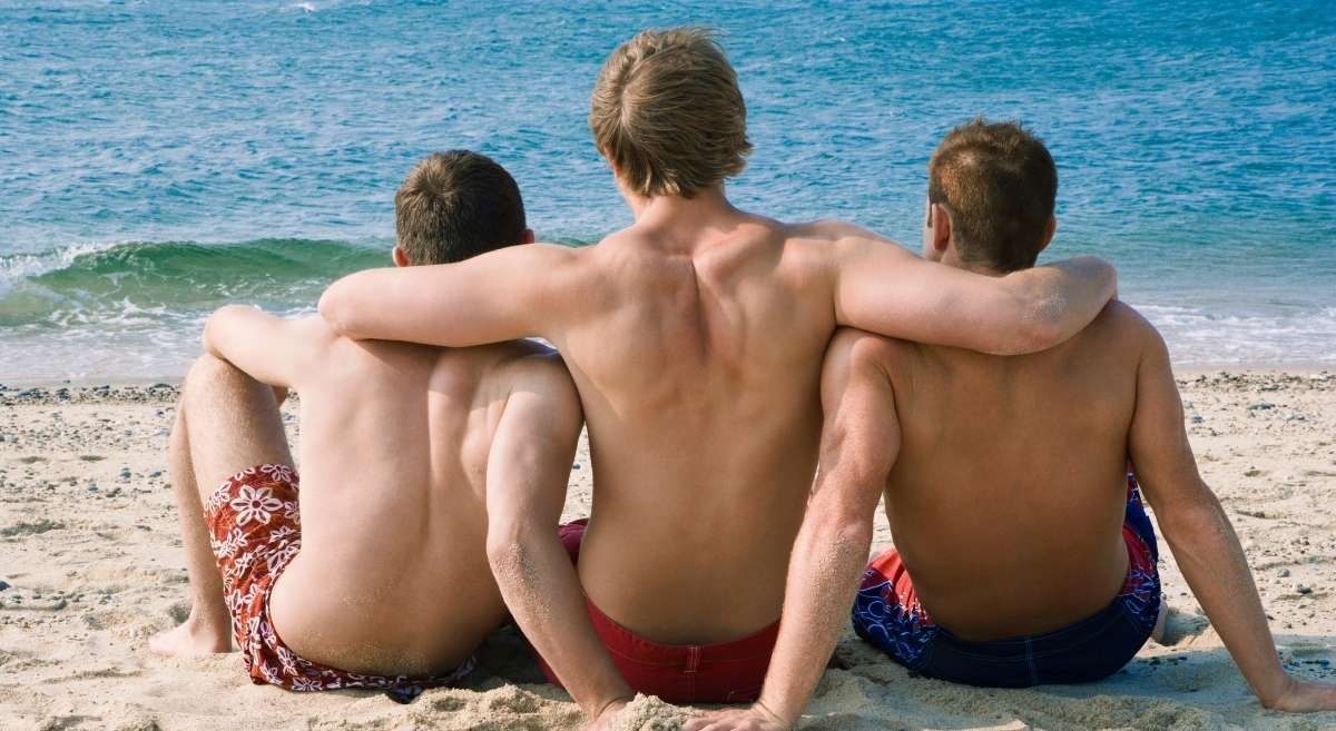 Guys enjoying a Guys’ Getaway on the beach.