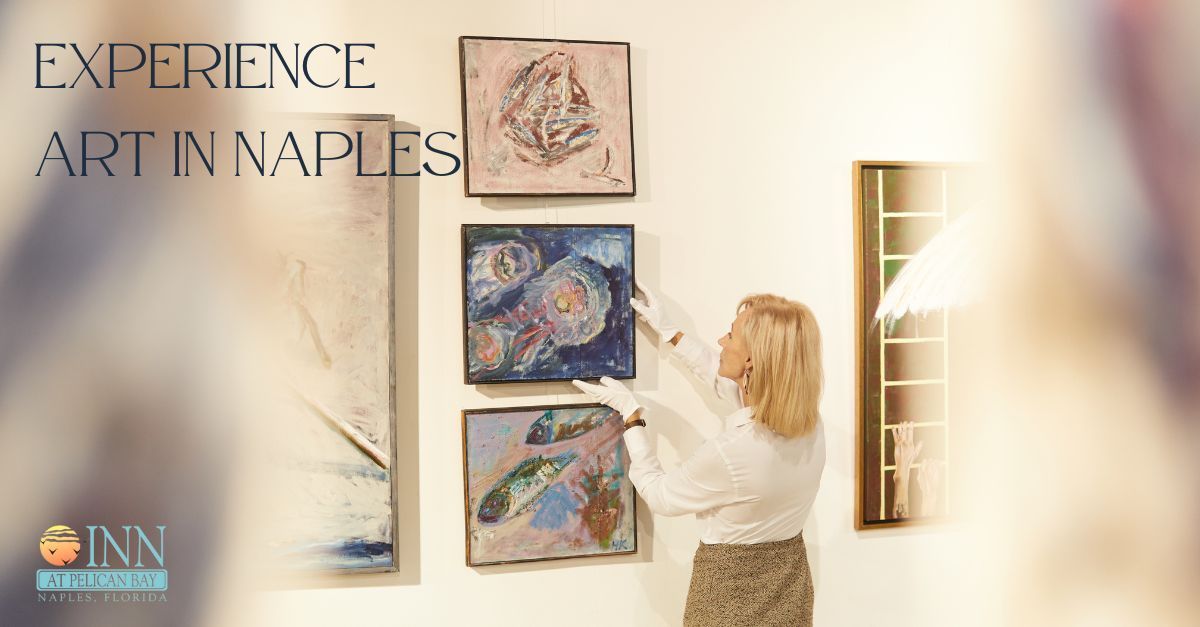 A woman is hanging a painting on a wall with the words experience art in naples on the bottom