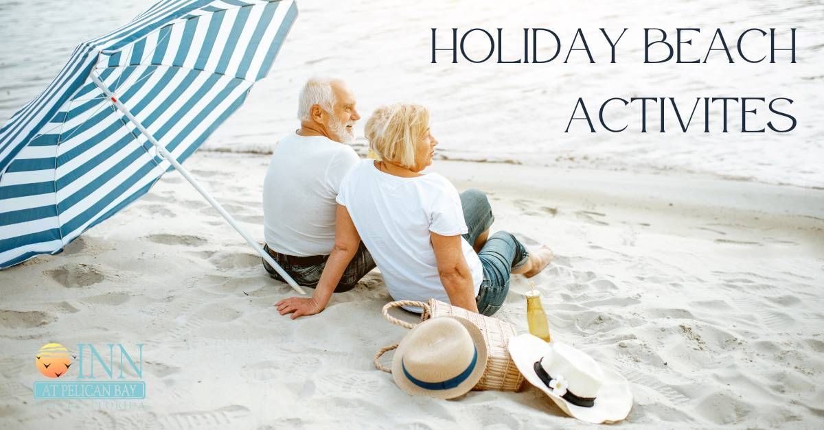 A man and a woman are sitting under an umbrella on the beach.