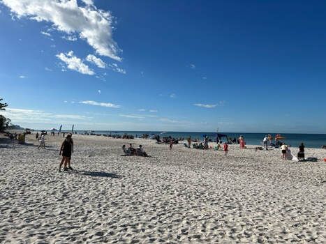 A group of people are playing volleyball on a beach.