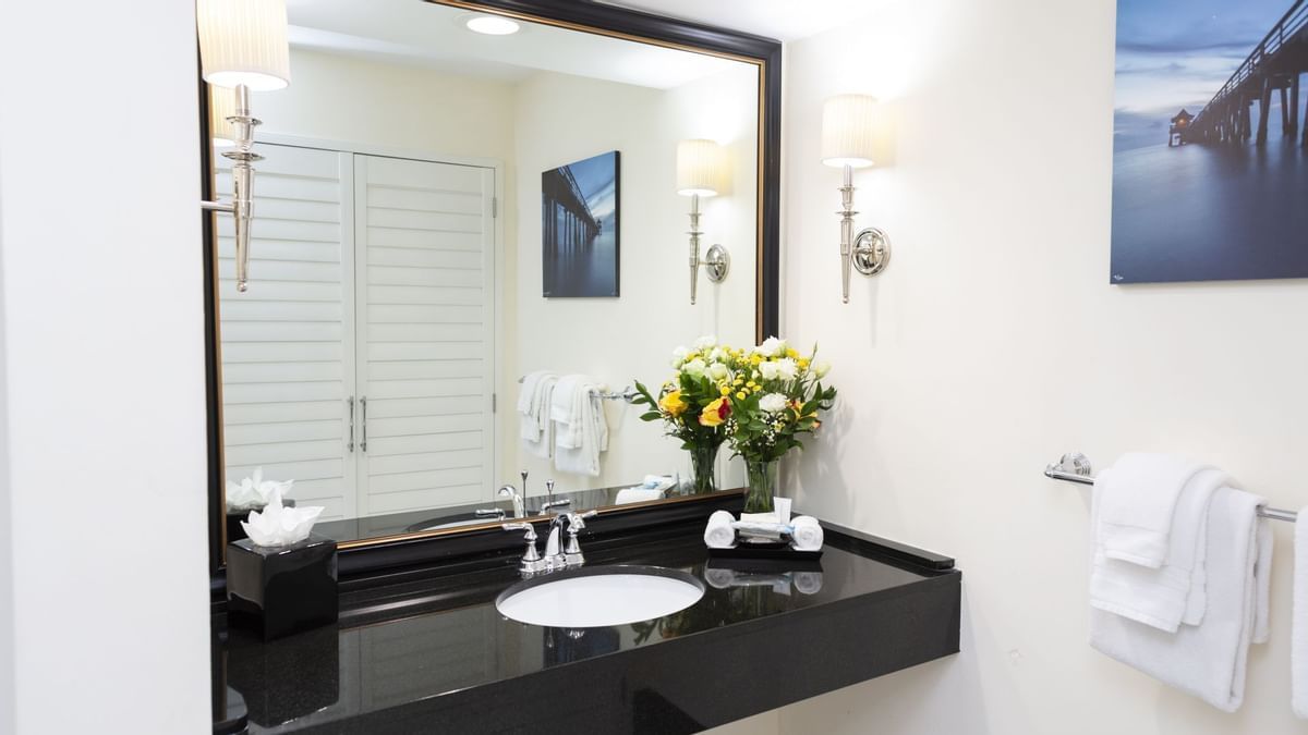 A bathroom with a sink and a large mirror