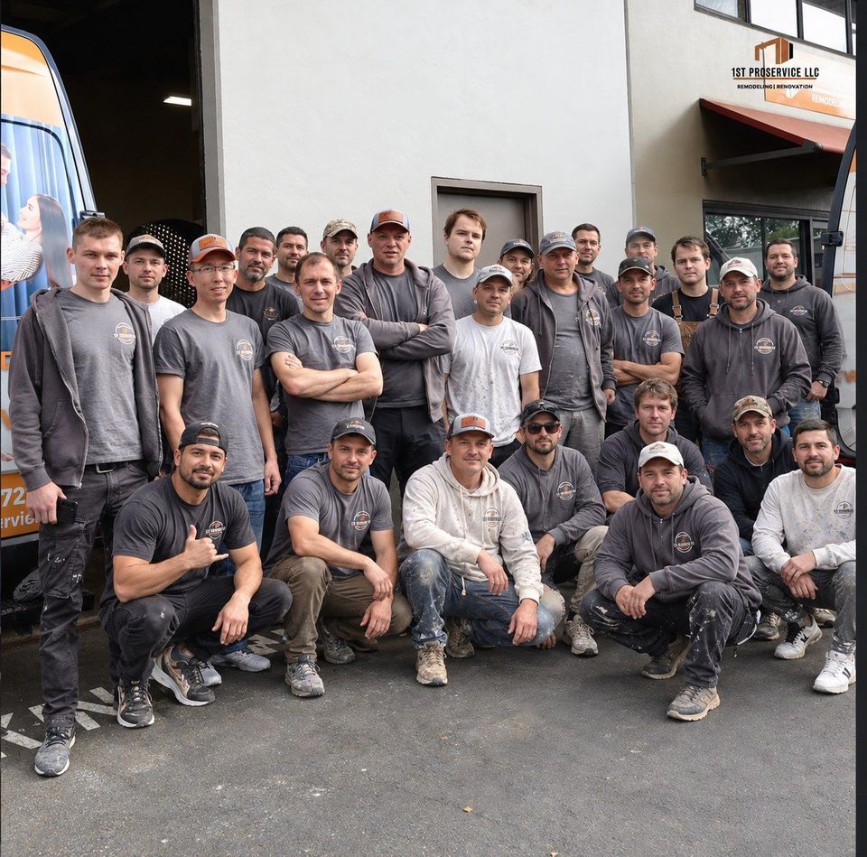 The 1st ProService remodeling crew standing together in front of company vans