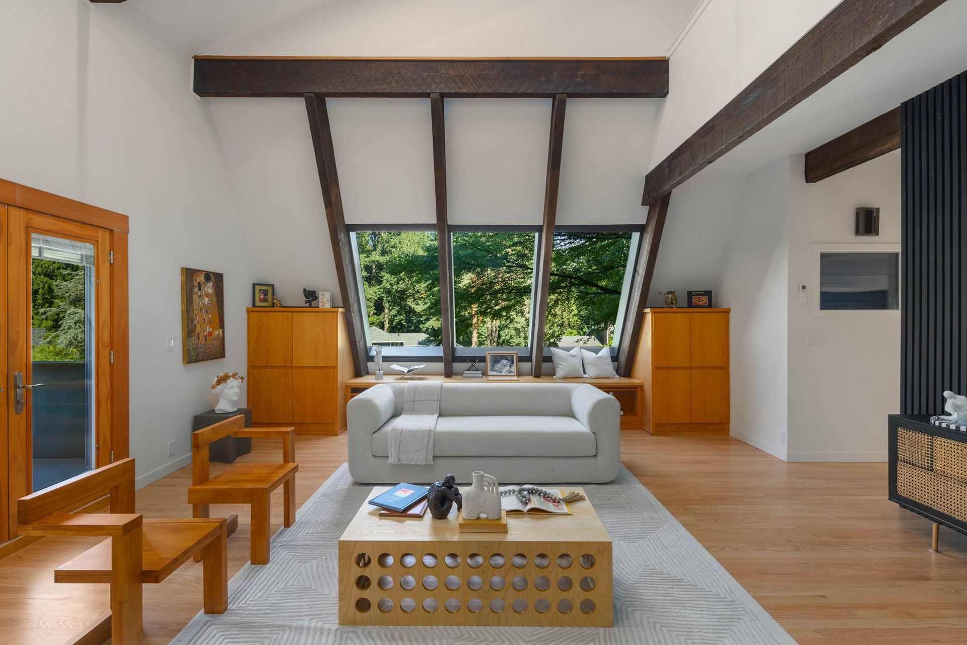 Completed vaulted living room with bright walls, timber beams and new flooring