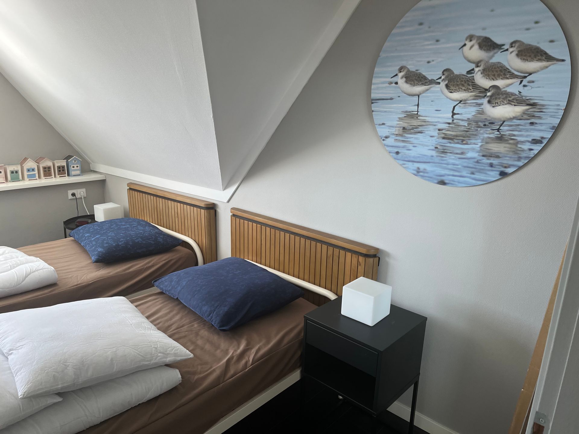 Slaapkamer van recreatievilla Vogelmient 15 met twee bedden en vogeldecoratie