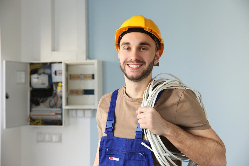 Electrician With Bunch Of Wires Indoors — Contact Us in Gympie, QLD