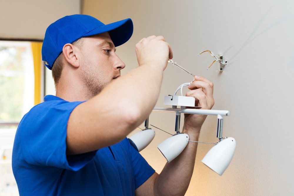 Installing Lamp On The Wall — Electrician on the Sunshine Coast, QLD