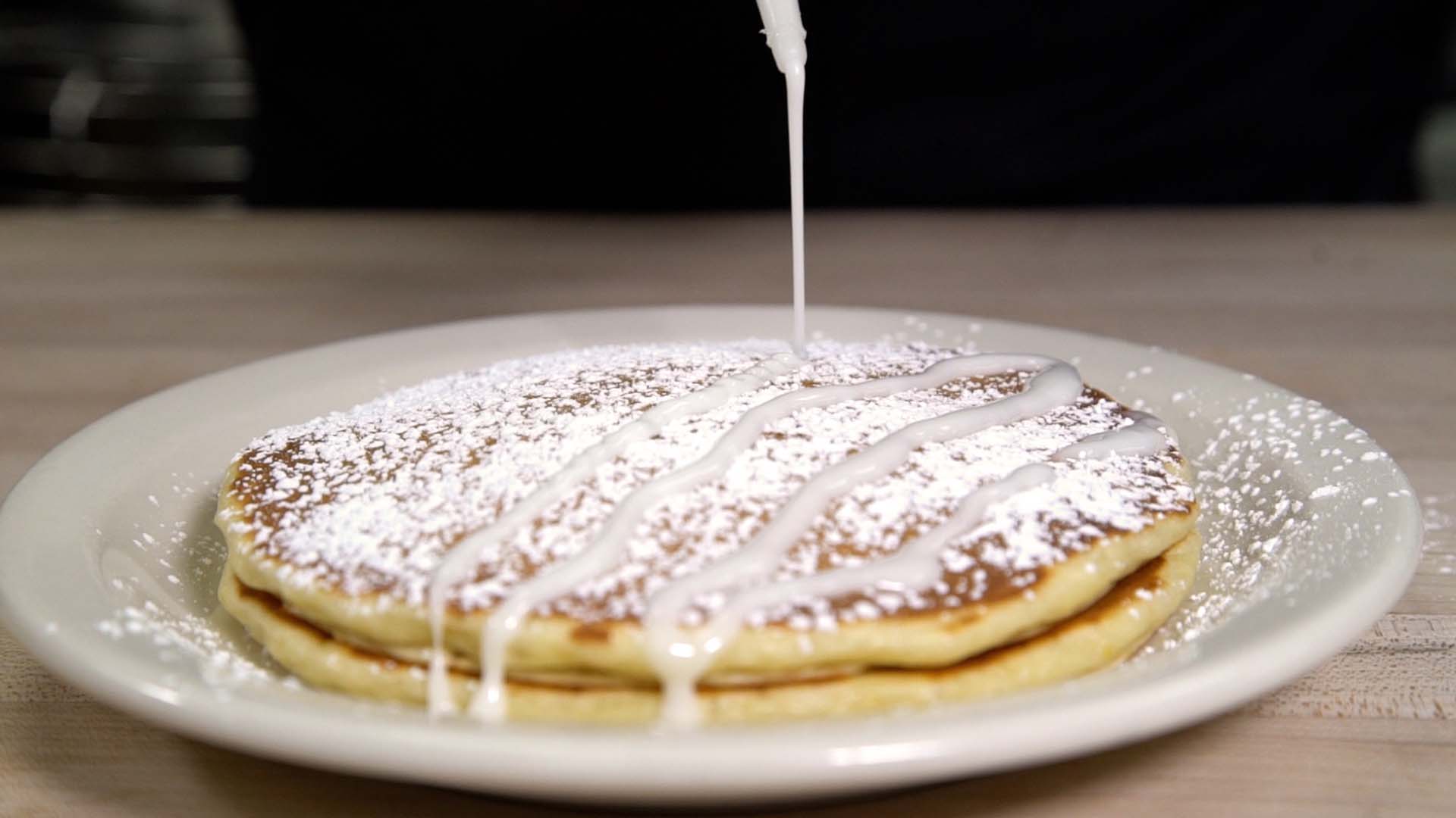 Scratch made lemon ricotta pancakes with a lemon drizzle.