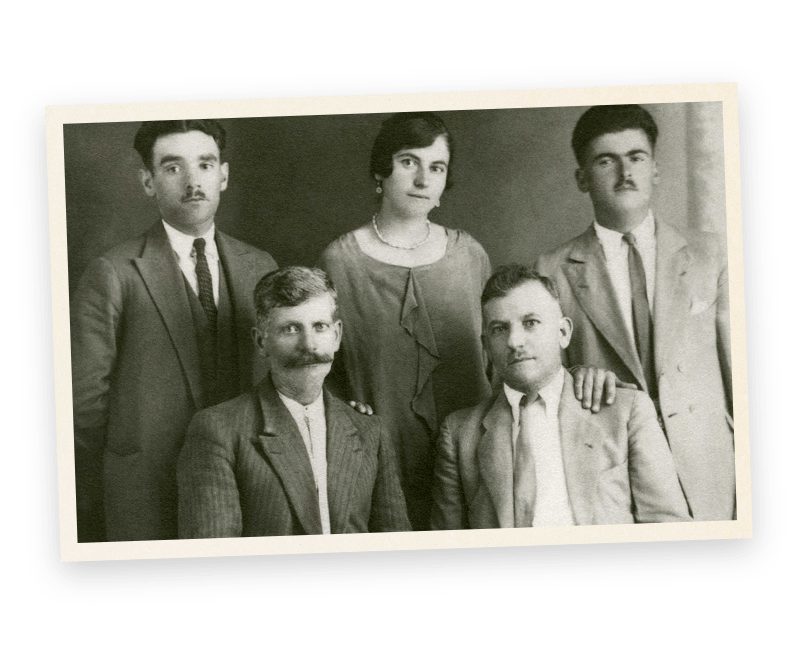 A black and white photo of a family posing for a picture