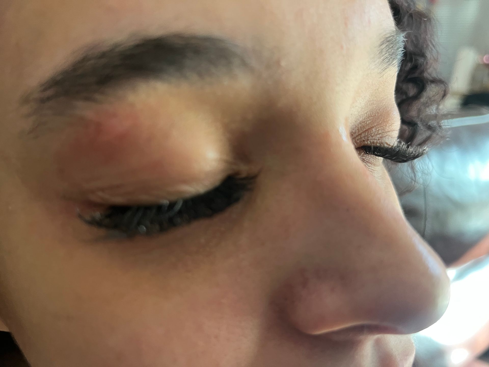 A close-up of a person's face with eyes closed.