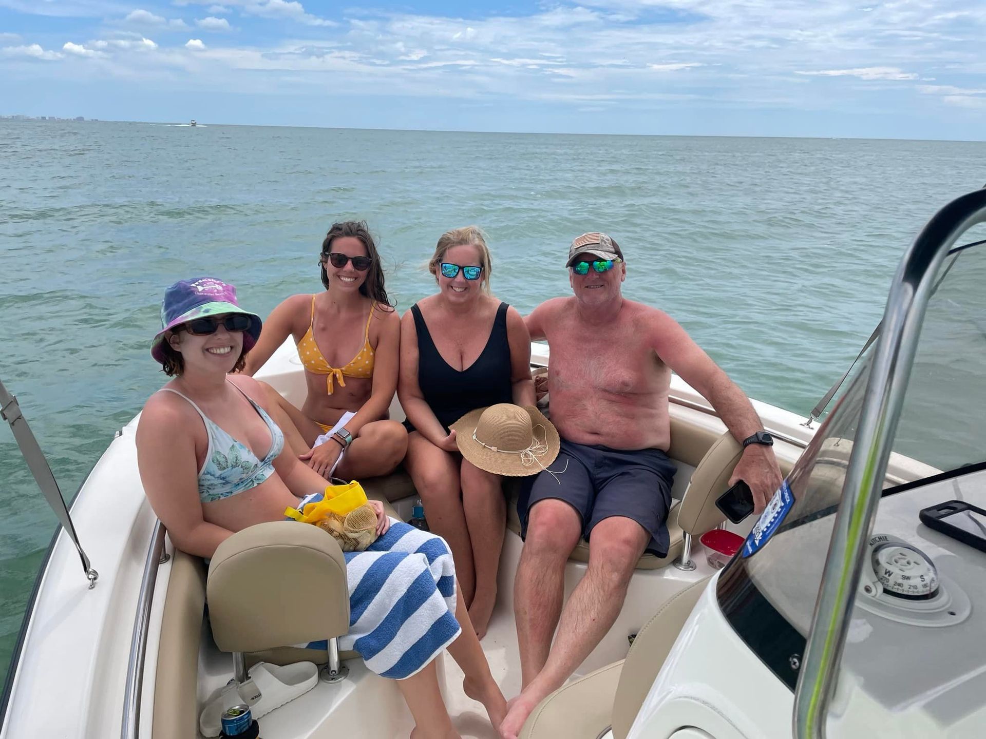 A group of people are sitting on a boat in the ocean.