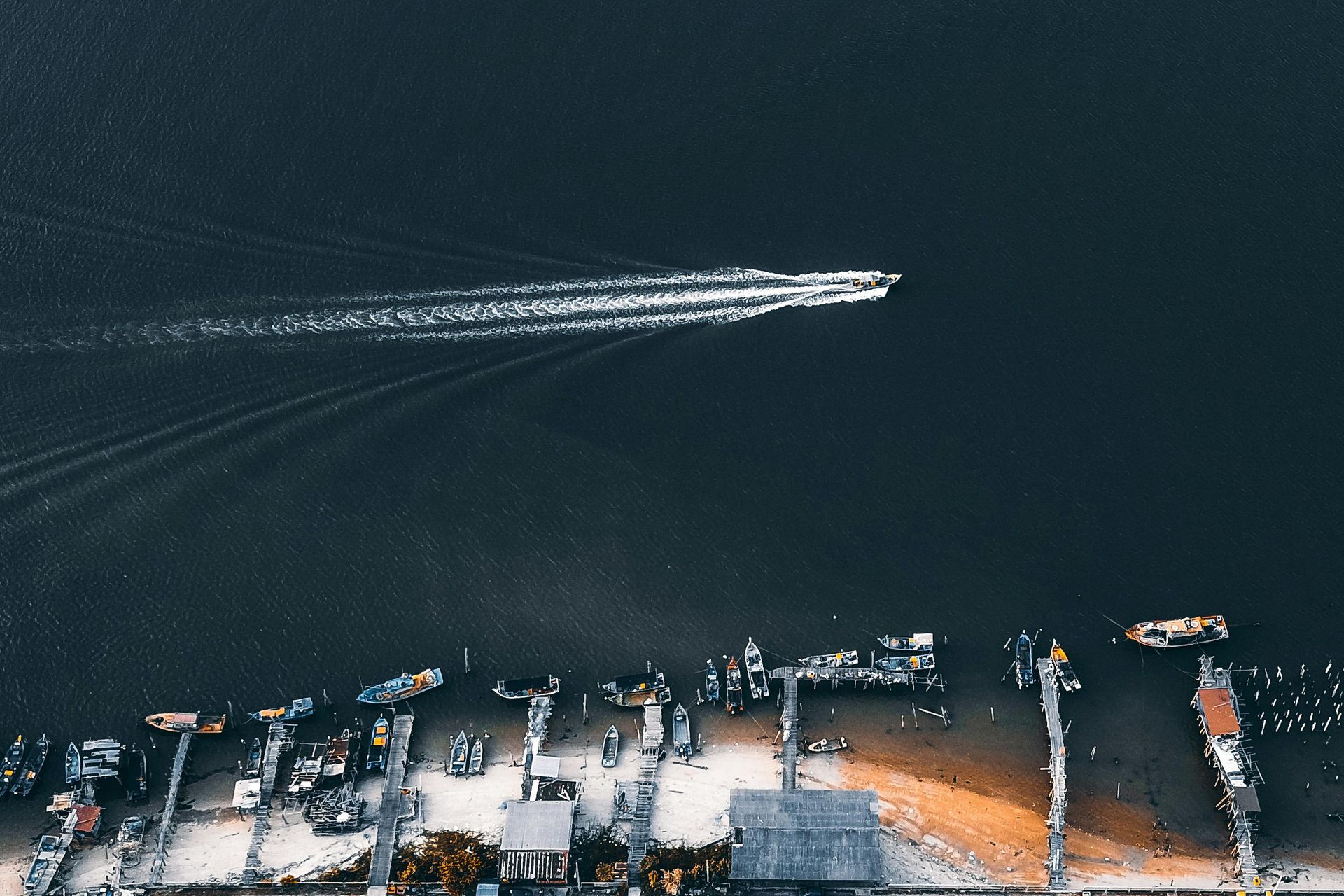 An aerial view of a body of water with boats in it