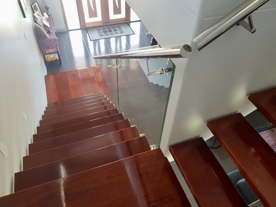The Stairs Are Made Of Wood And Have A Glass Railing — Ward's Aluminium in Garbutt, QLD