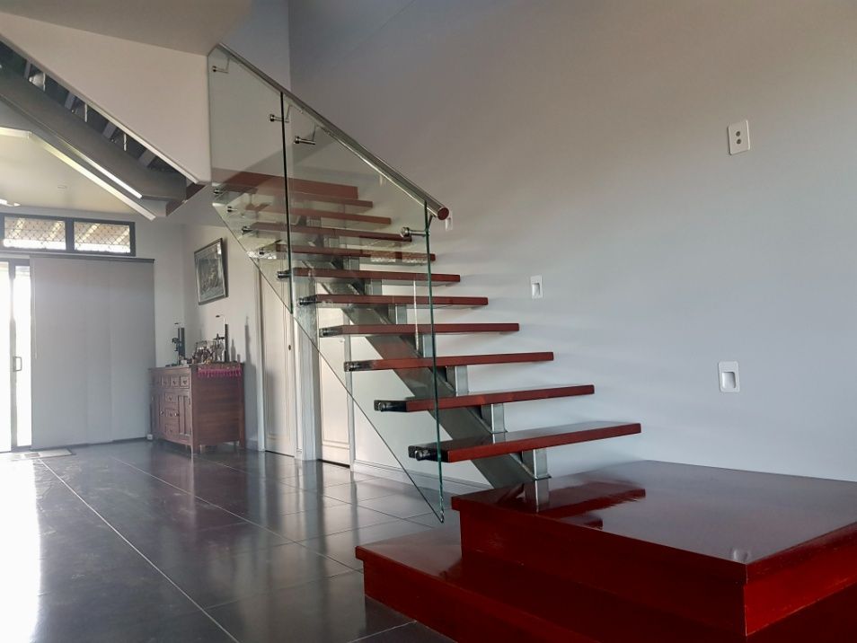 A Staircase With Red Steps And A Glass Railing — Ward's Aluminium in Garbutt, QLD