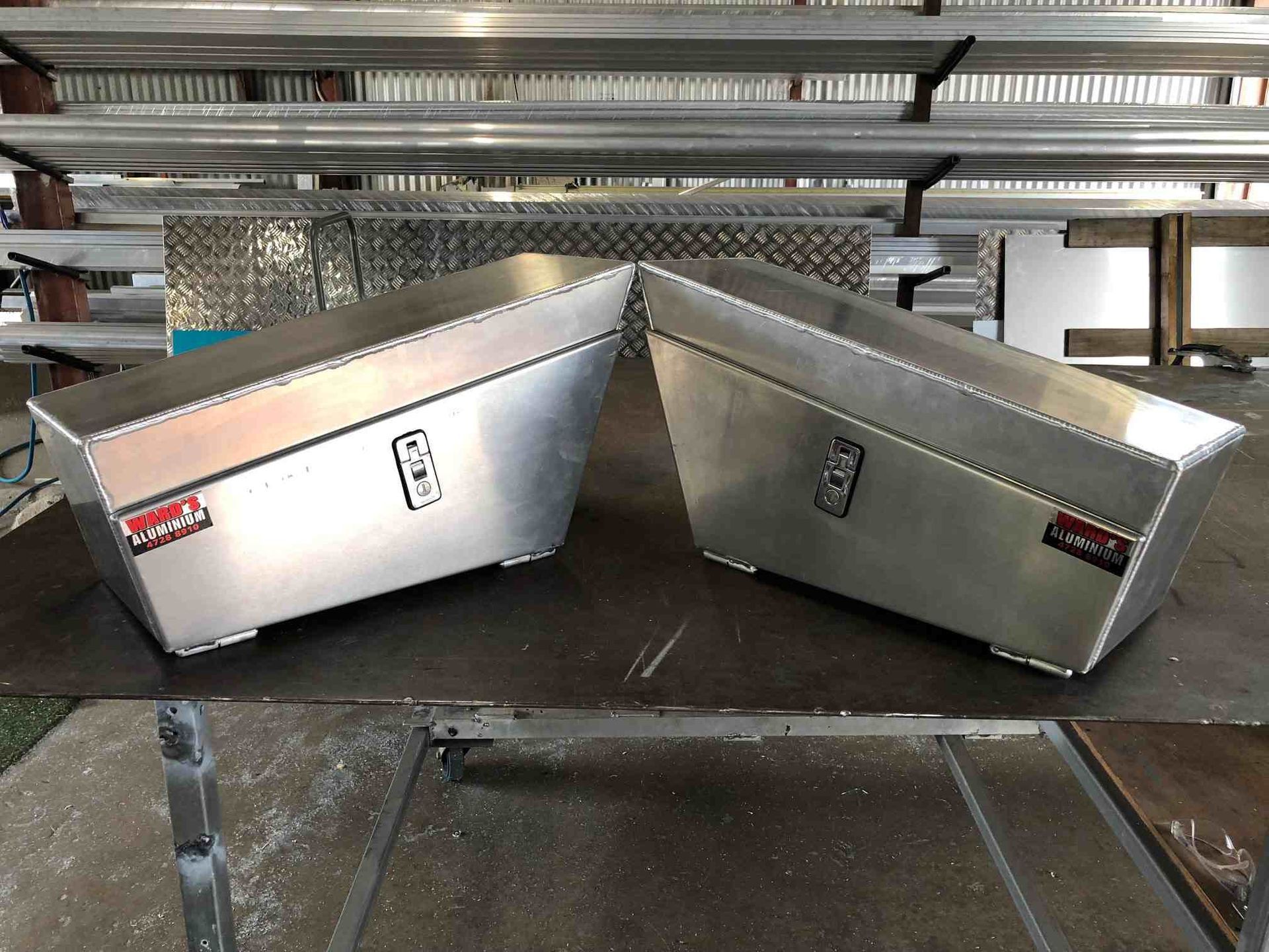 Two Aluminum Boxes Are Sitting On Top Of A Metal Table — Ward's Aluminium in Garbutt, QLD