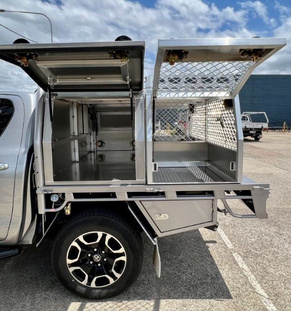A Silver Truck With The Canopy Open Is Parked In A Parking Lot — Ward's Aluminium in Garbutt, QLD
