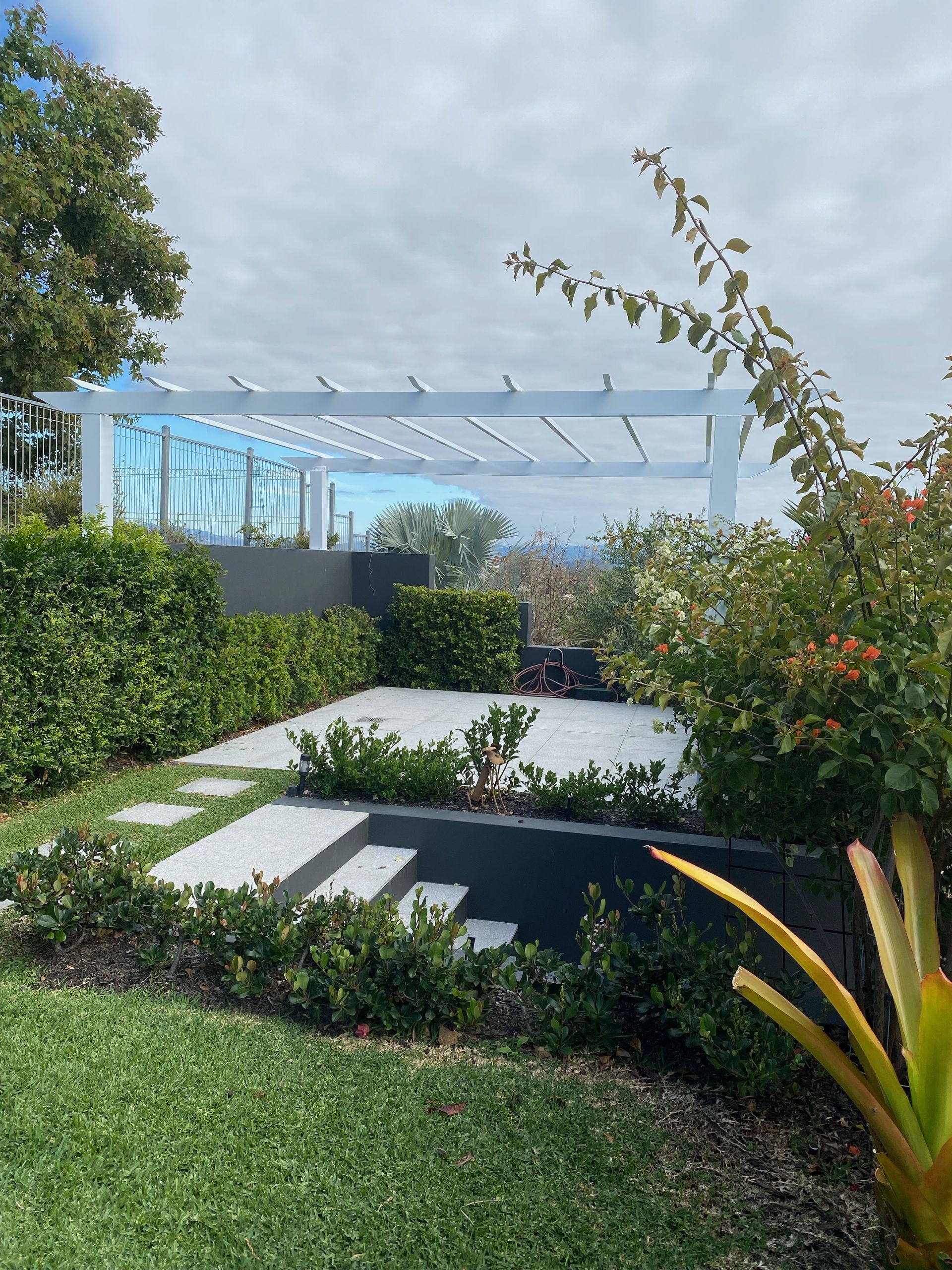 A patio with concrete steps and plants around it — Ward's Aluminium in Ingham, QLD