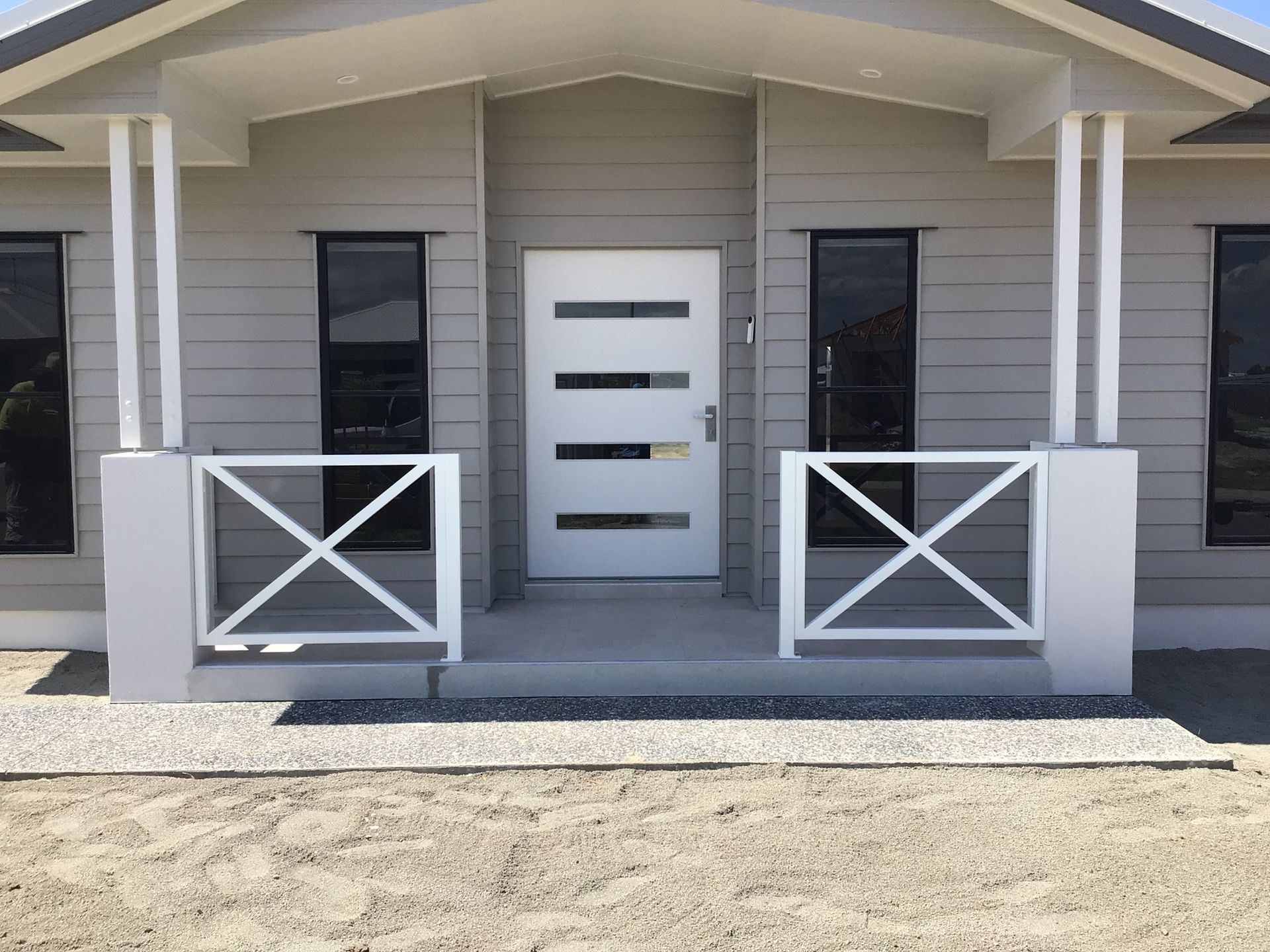 A Grey House With A White Door And Black Windows — Ward's Aluminium in Garbutt, QLD