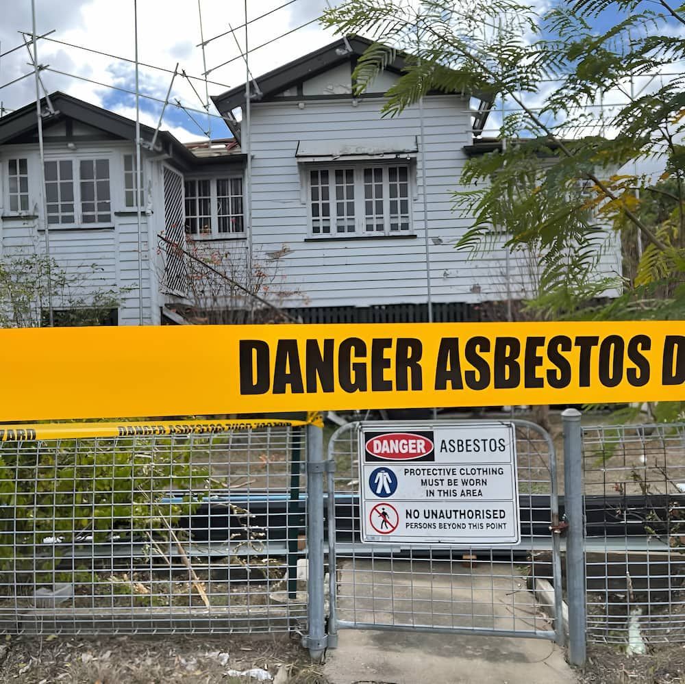 A House With a Danger Asbestos Sign in Front of It — Veramax Industries in Park Avenue, QLD