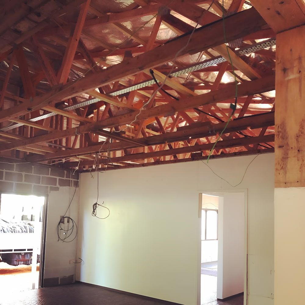 An Empty Room With a Wooden Ceiling and White Walls — Veramax Industries in Park Avenue, QLD