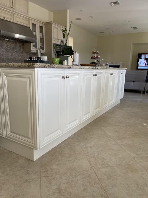 A kitchen with white cabinets and granite counter tops
