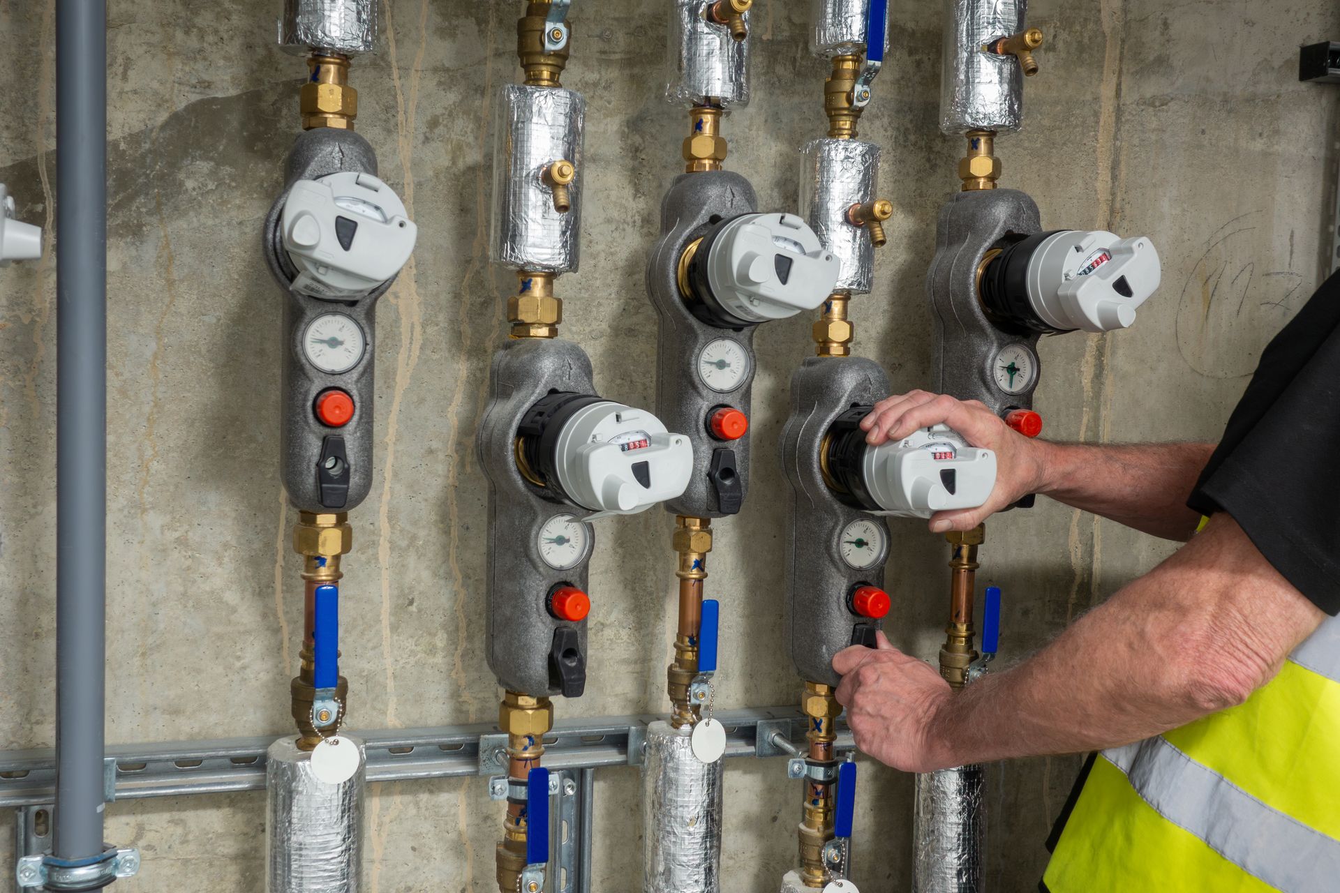Plumbing engineer investigating a faulty water usage meter.