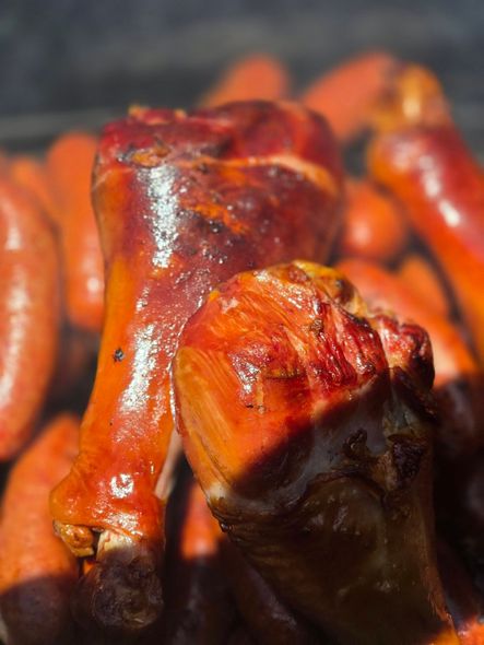 Close-up of glazed roasted meat drumsticks with a glossy reddish-brown finish