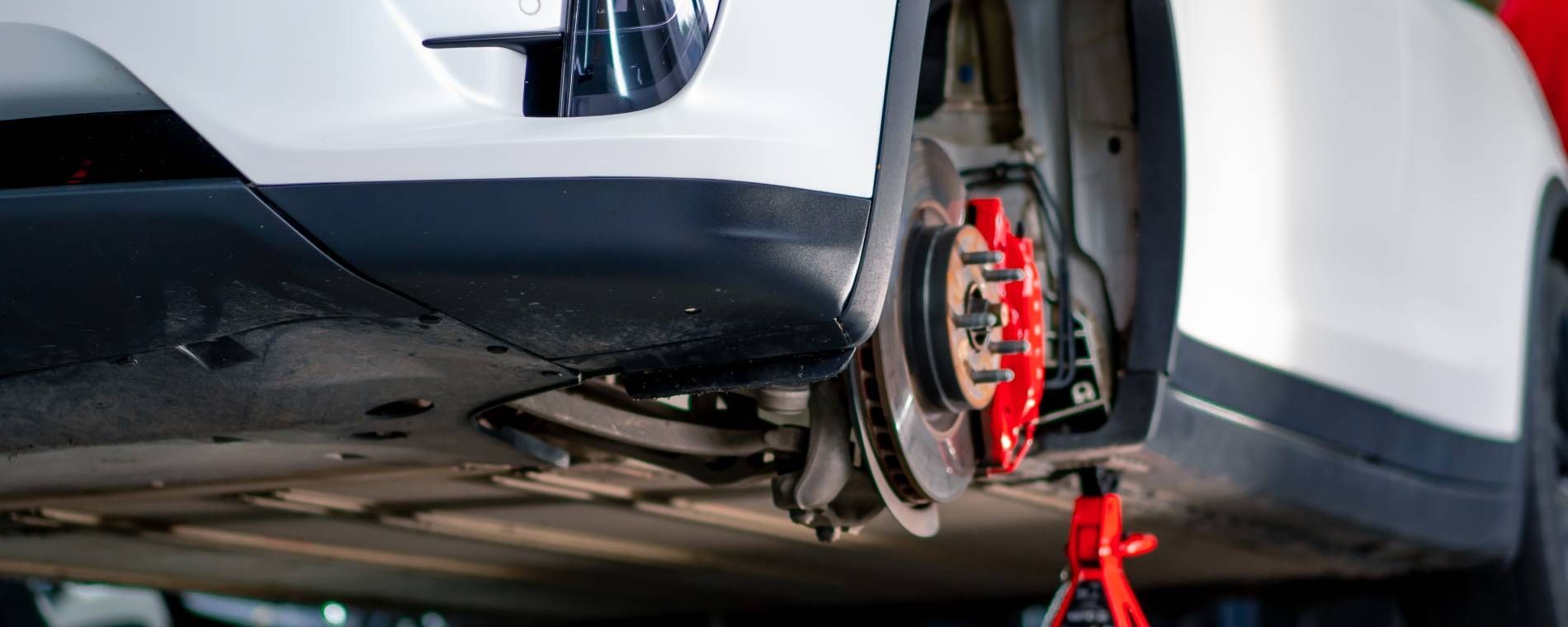 ASE-certified technician performing a brake fluid flush during routine brake maintenance at a Mariet