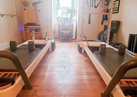 An image of the Bentley Bodies Pilates studio reformers.