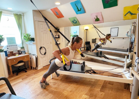 Victoria Bentley demonstrating Pilates exercises in her home studio.