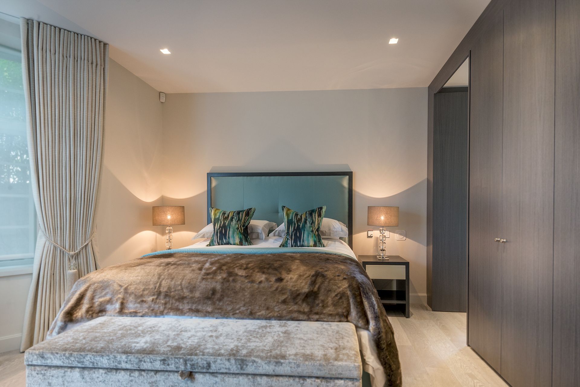 a bedroom with a king size bed and a bench 