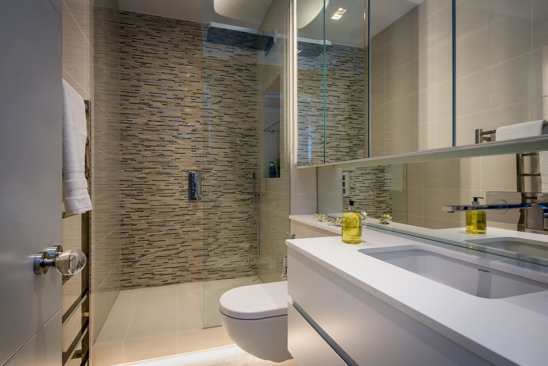 a bathroom with a toilet, sink and shower 