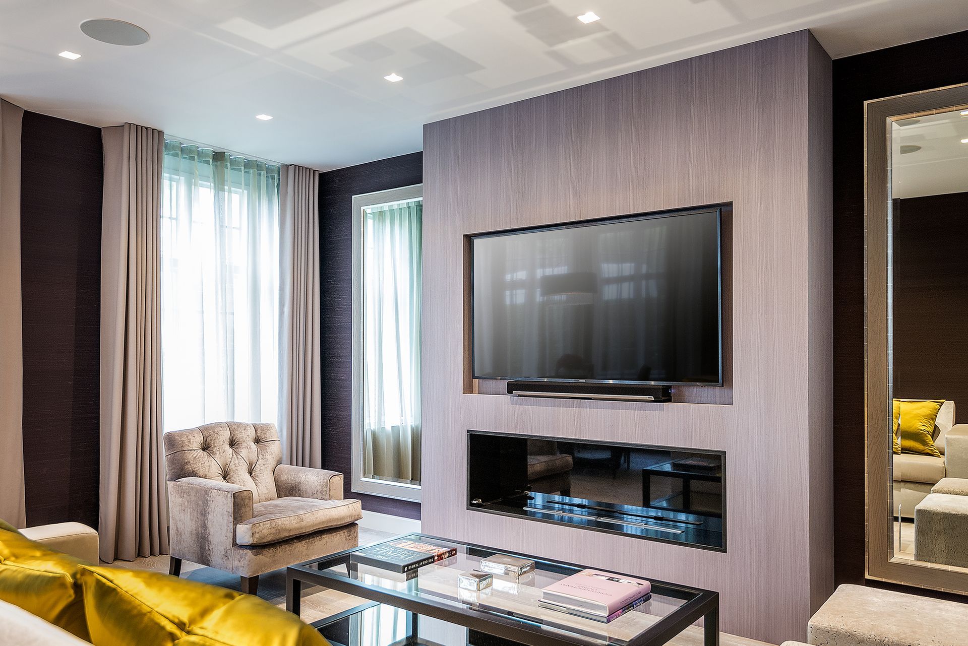 a living room with a fireplace and a flat screen tv