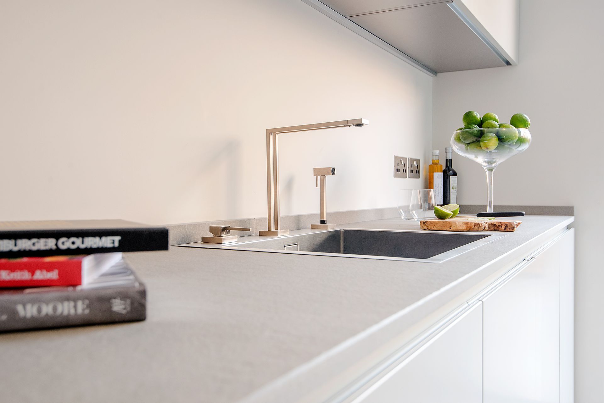 a kitchen with a sink and a book titled burger gourmet