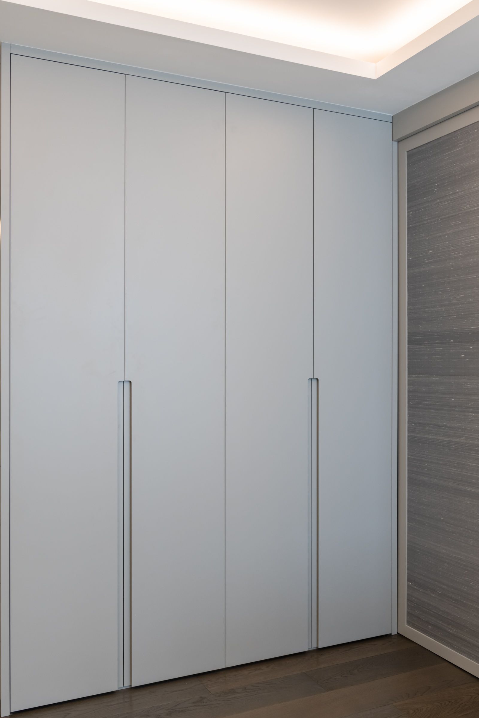 a room with a large white wall and a wooden floor 