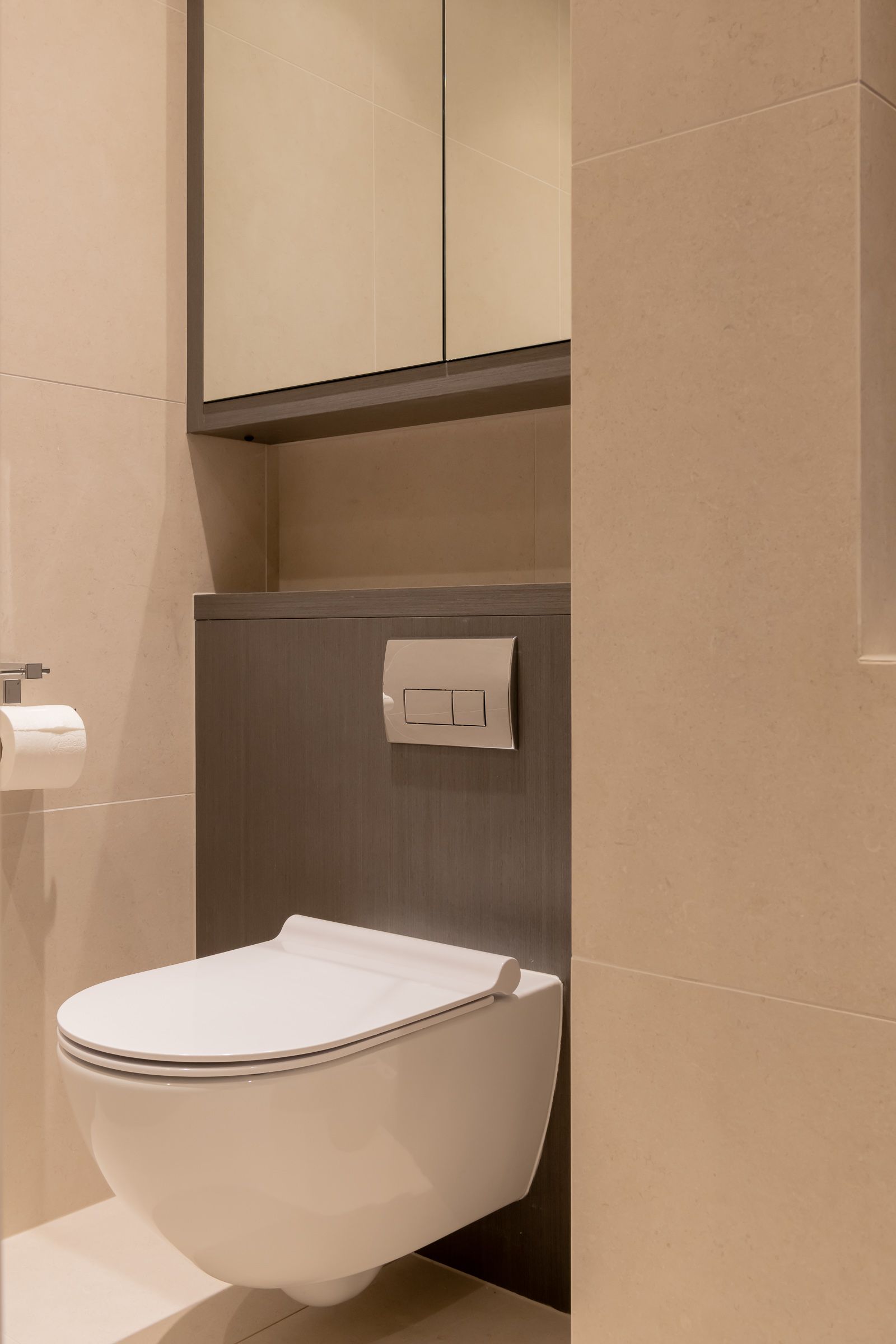 a toilet is mounted to the wall in a bathroom next to a sink 