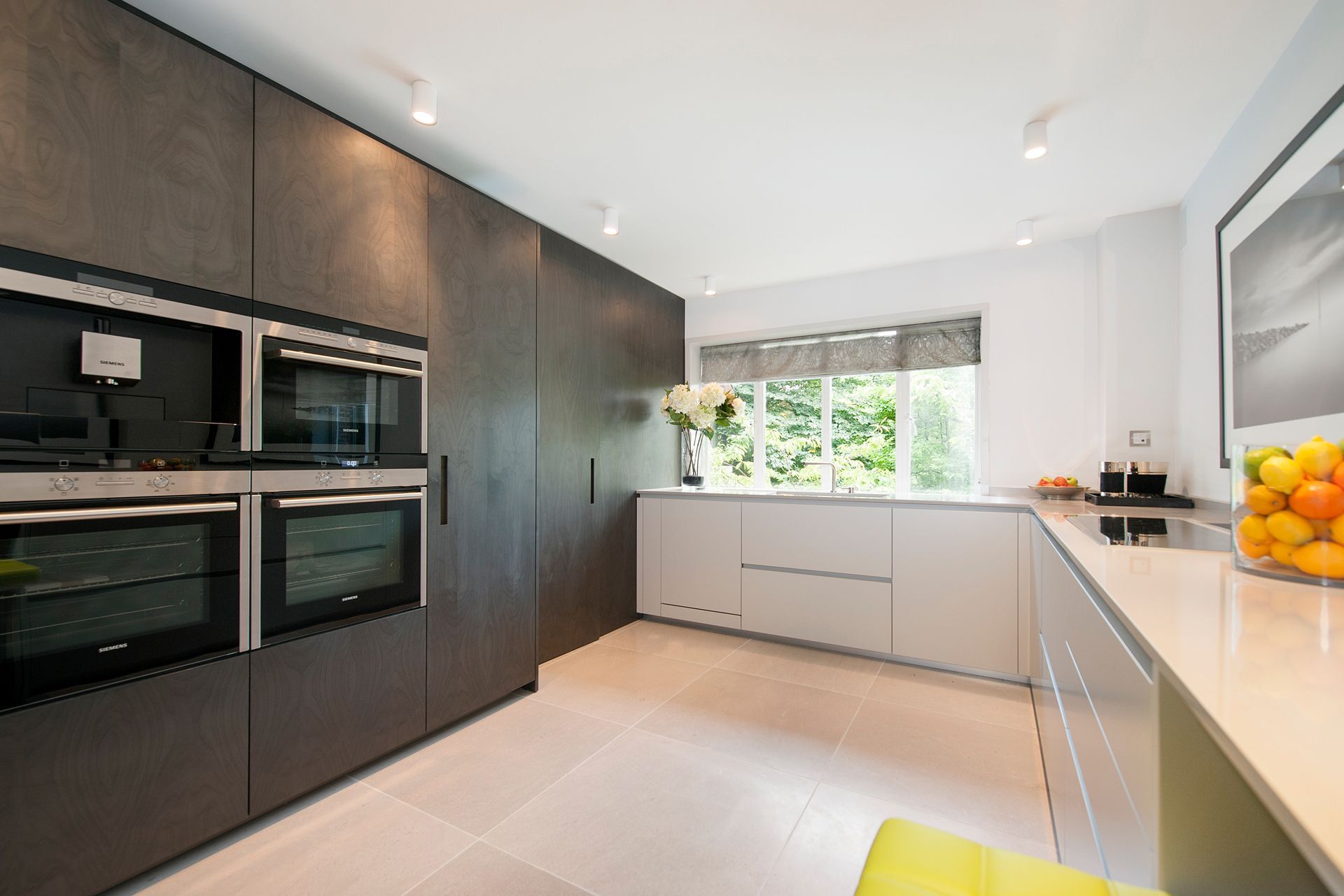 a kitchen with a bowl of oranges on the counter