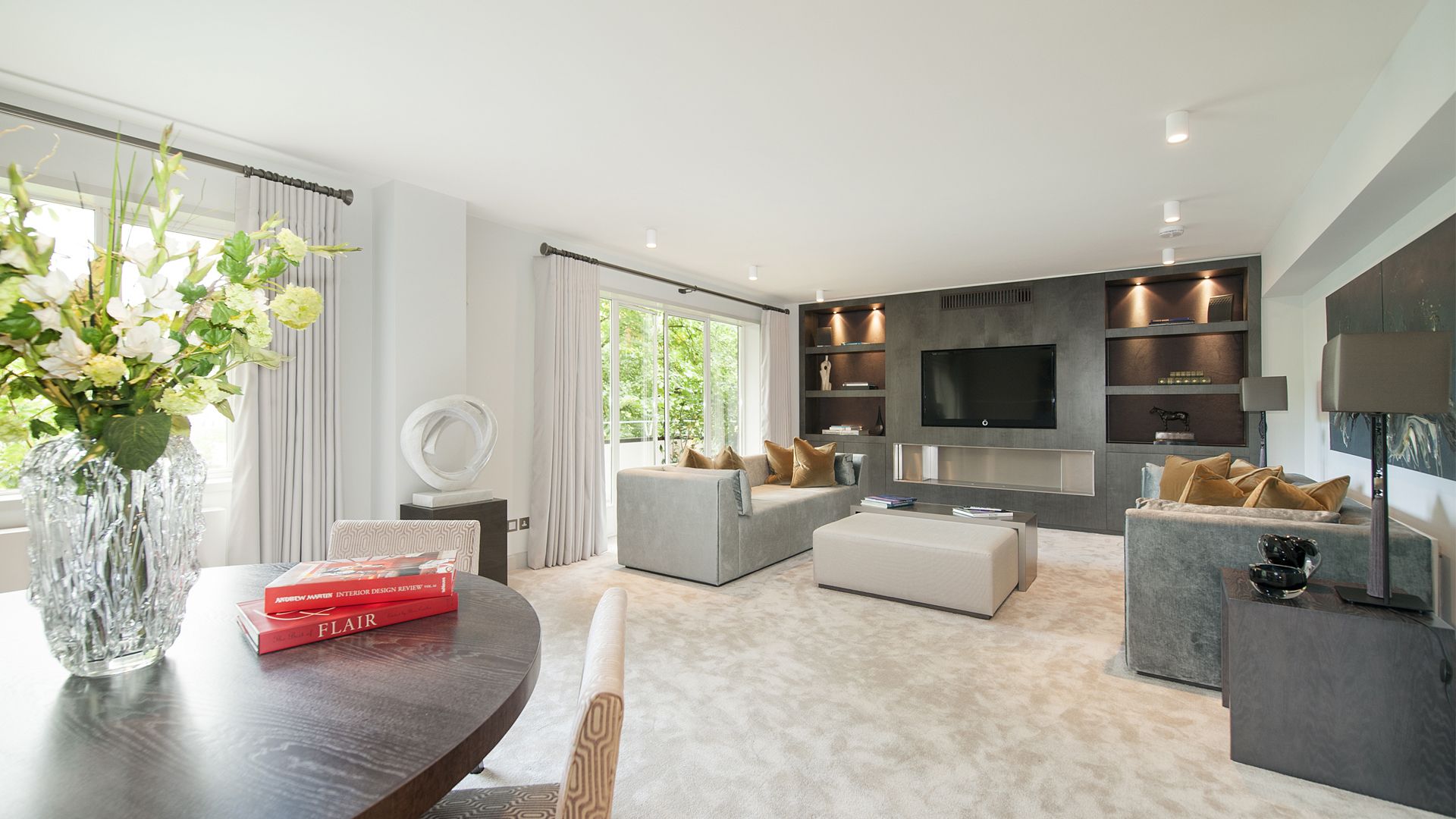 a living room with a table , chairs , couch , and television