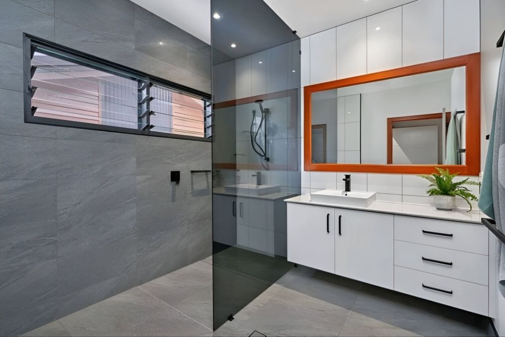 A Kitchen With White Cabinets, Stools and a Refrigerator — ROGA Build Solutions in Atherton, QLD