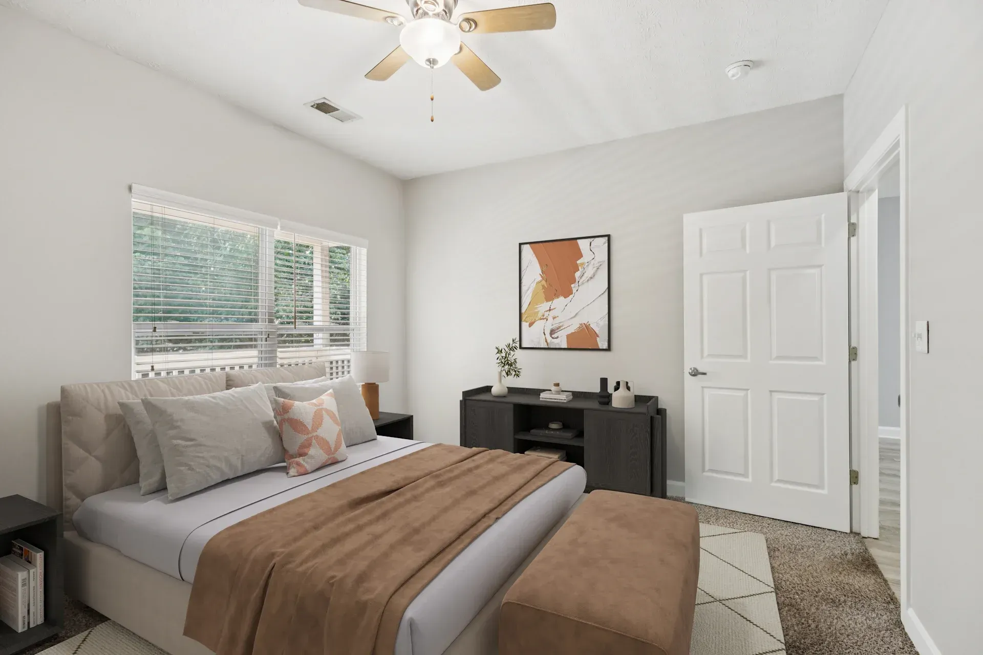Bedroom with bed, dresser, window, and closed door. Light colors, neutral decor.