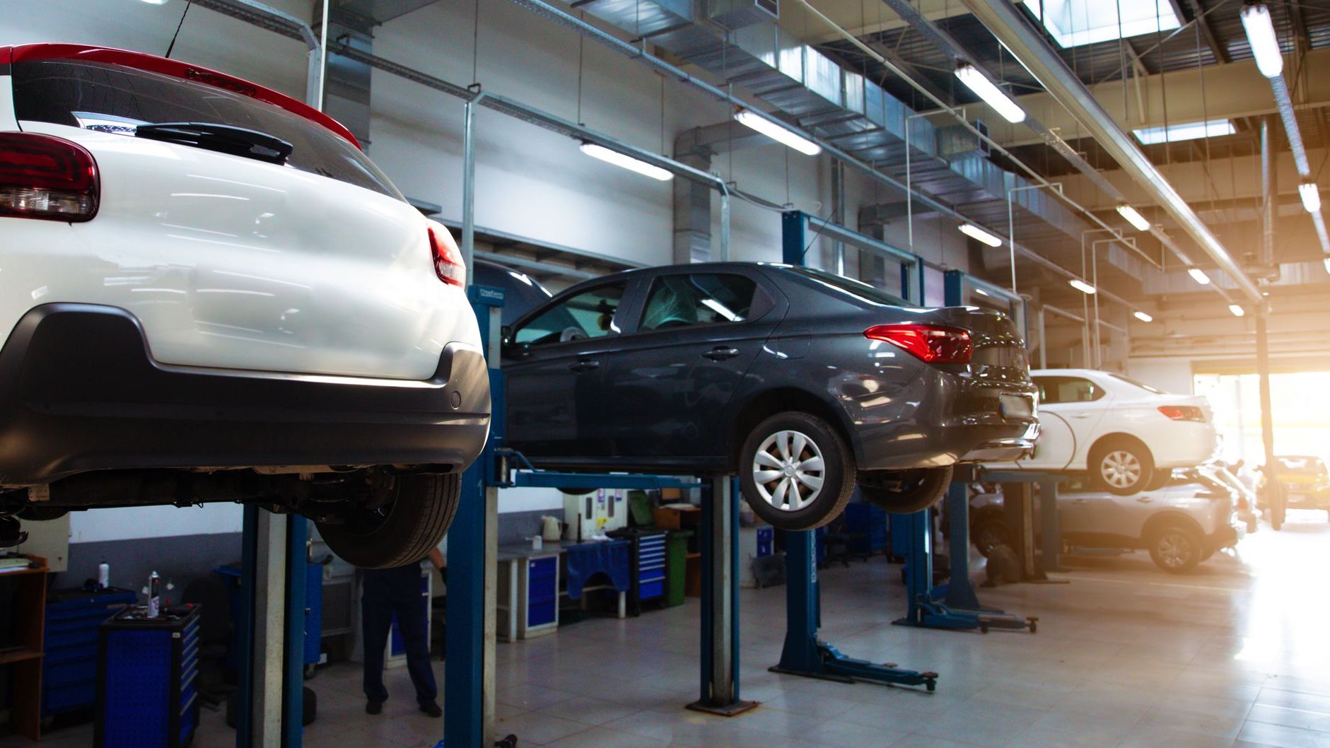 Une voiture est assise sur un ascenseur dans un garage.