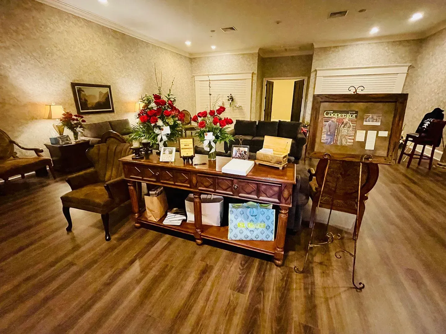 Elegant dining room with polished wood table, floral centerpiece, and fireplace in the background