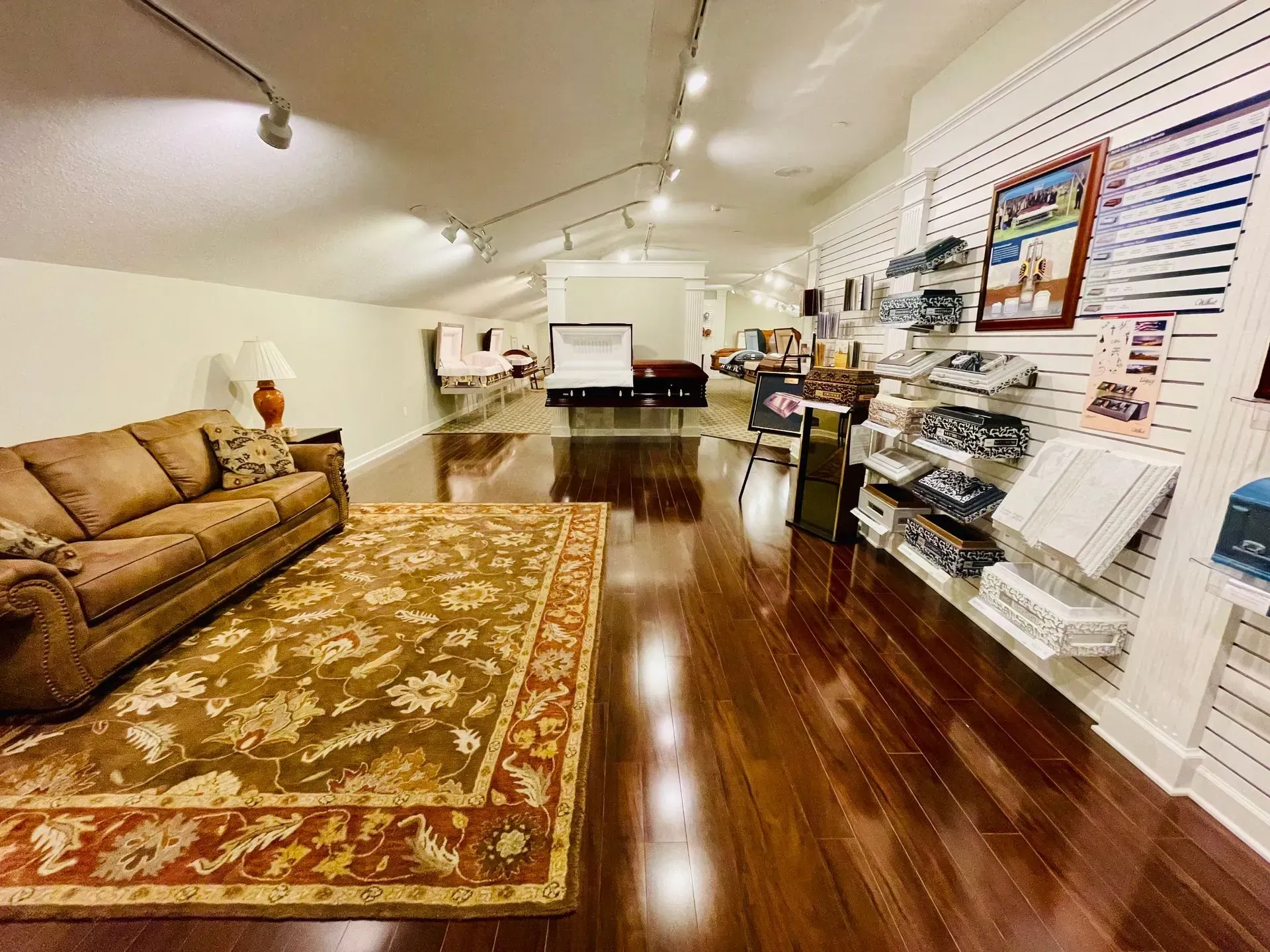 Bright interior of a furniture store with sofas, rugs, polished wood floors, and wall displays