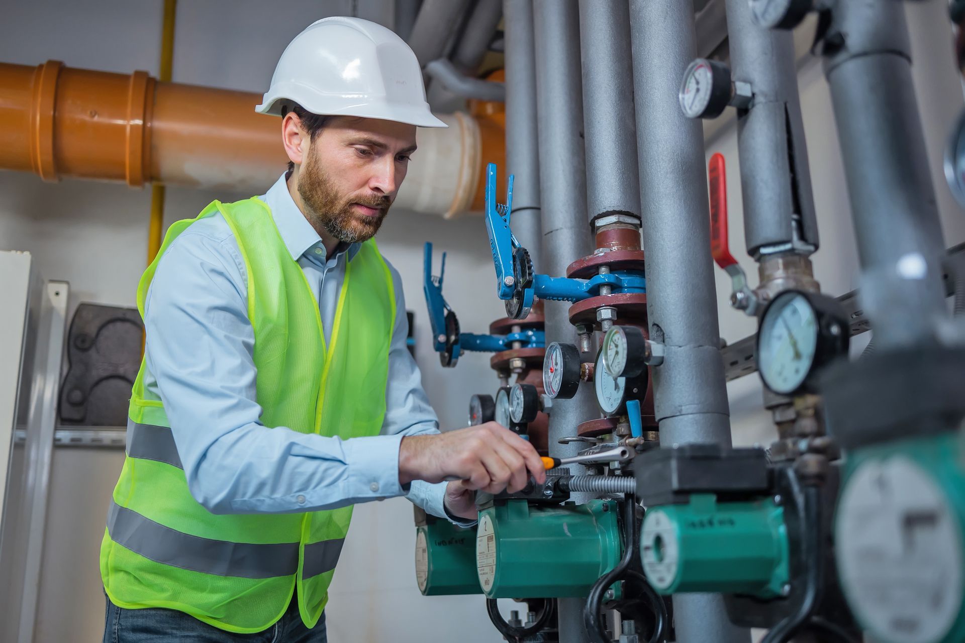 Engineer checks industrial pipe installation.
