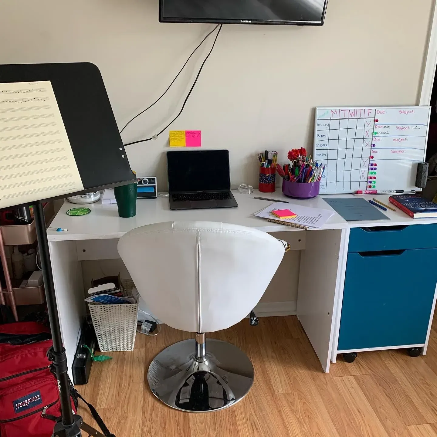 A desk with a chair and a laptop on it