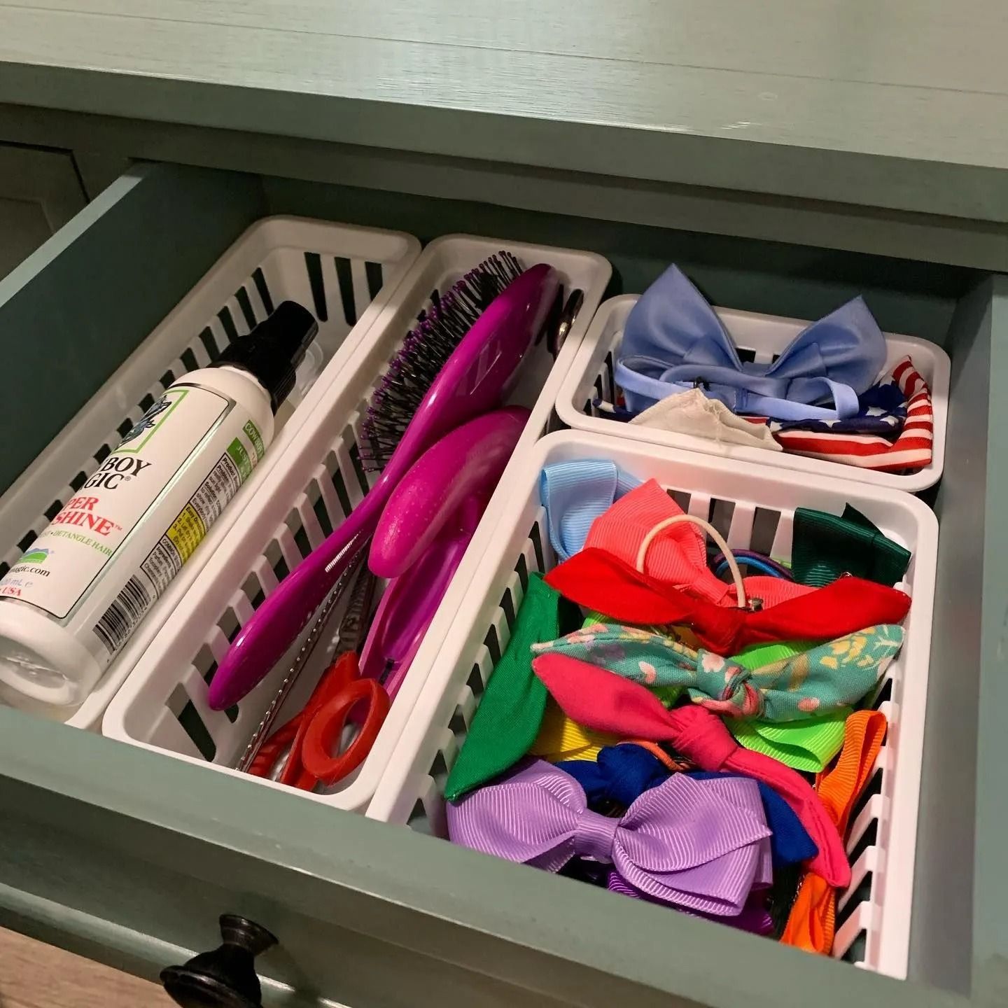 A drawer filled with a variety of hair accessories