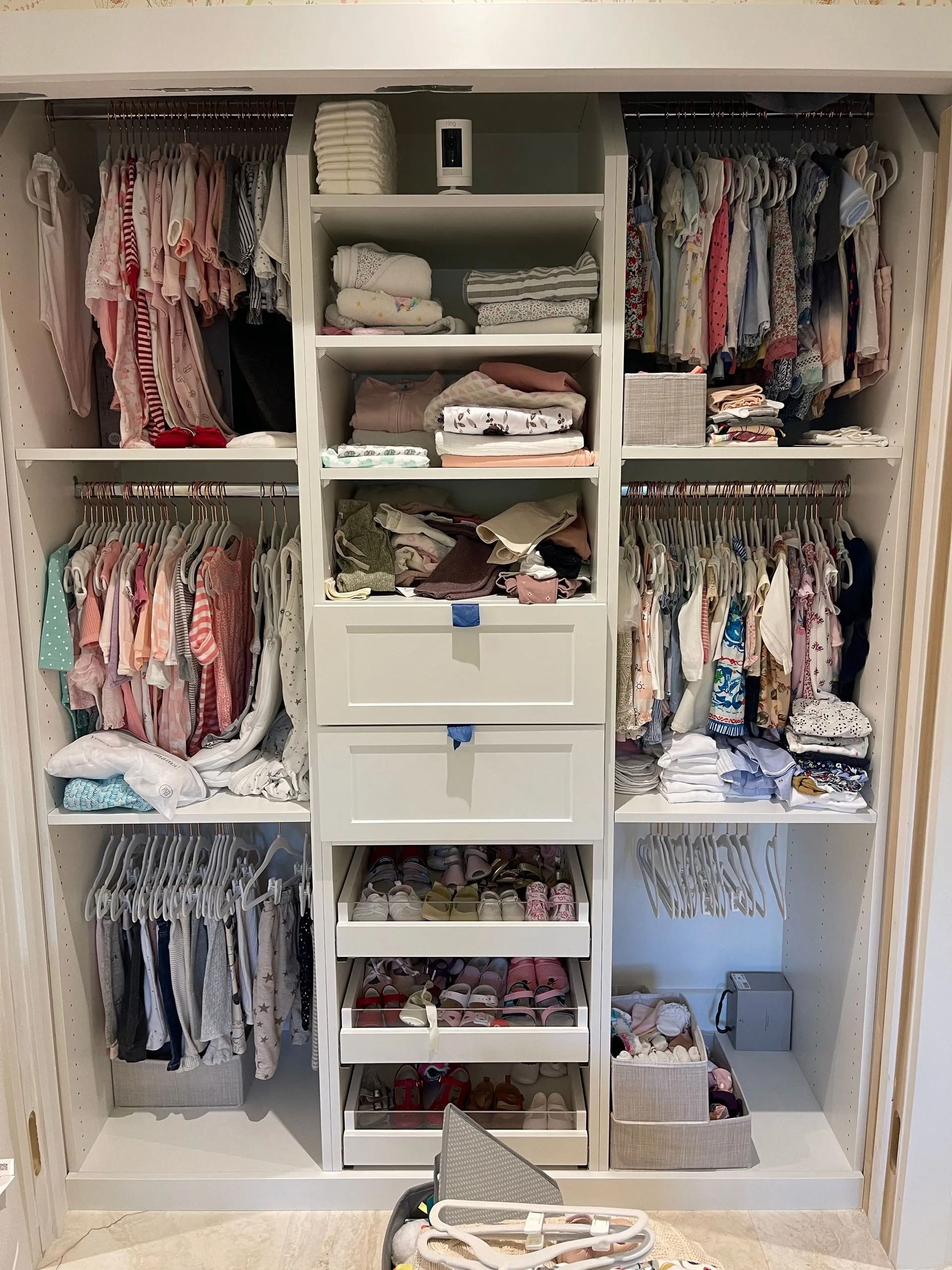 A closet filled with lots of clothes and drawers.