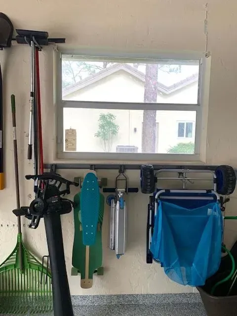 A garage with a skateboard hanging on the wall